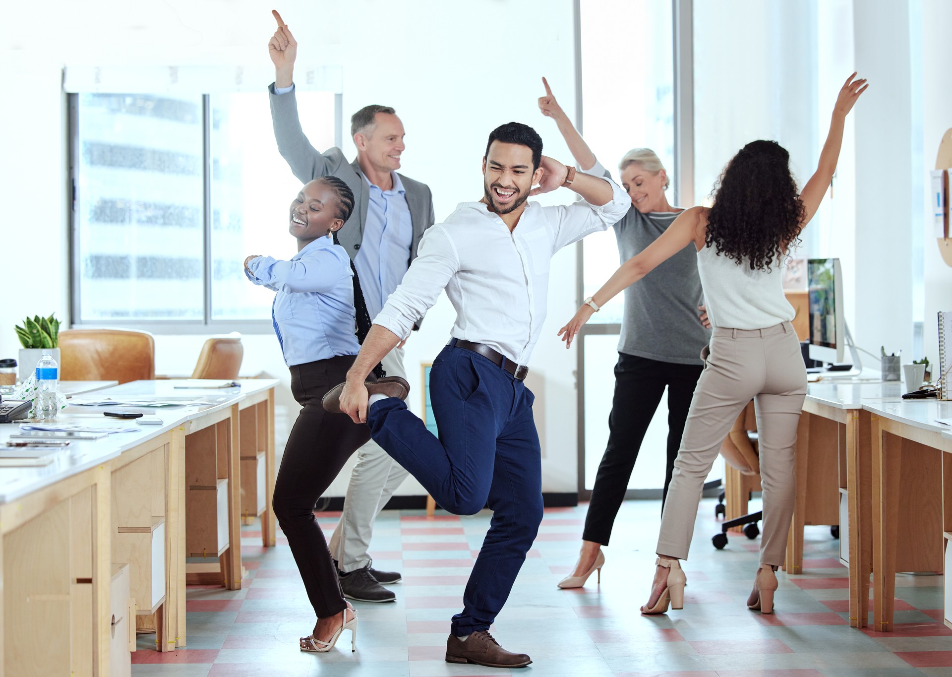 Shot of a group of businesspeople dancing in an office at work