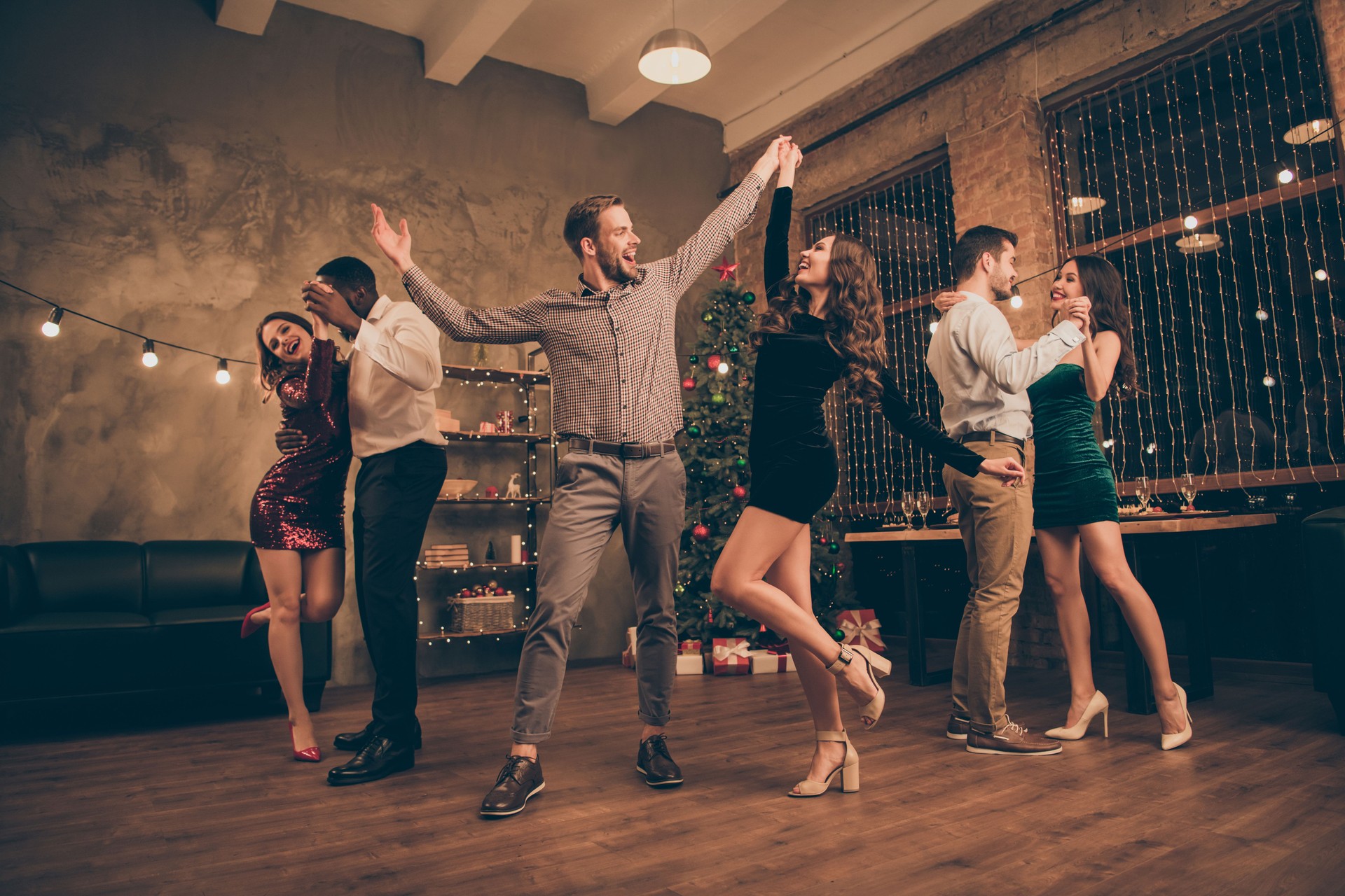 Full length photo of cheerful lover dance have christmas time x-mas party in house with newyear lights indoors