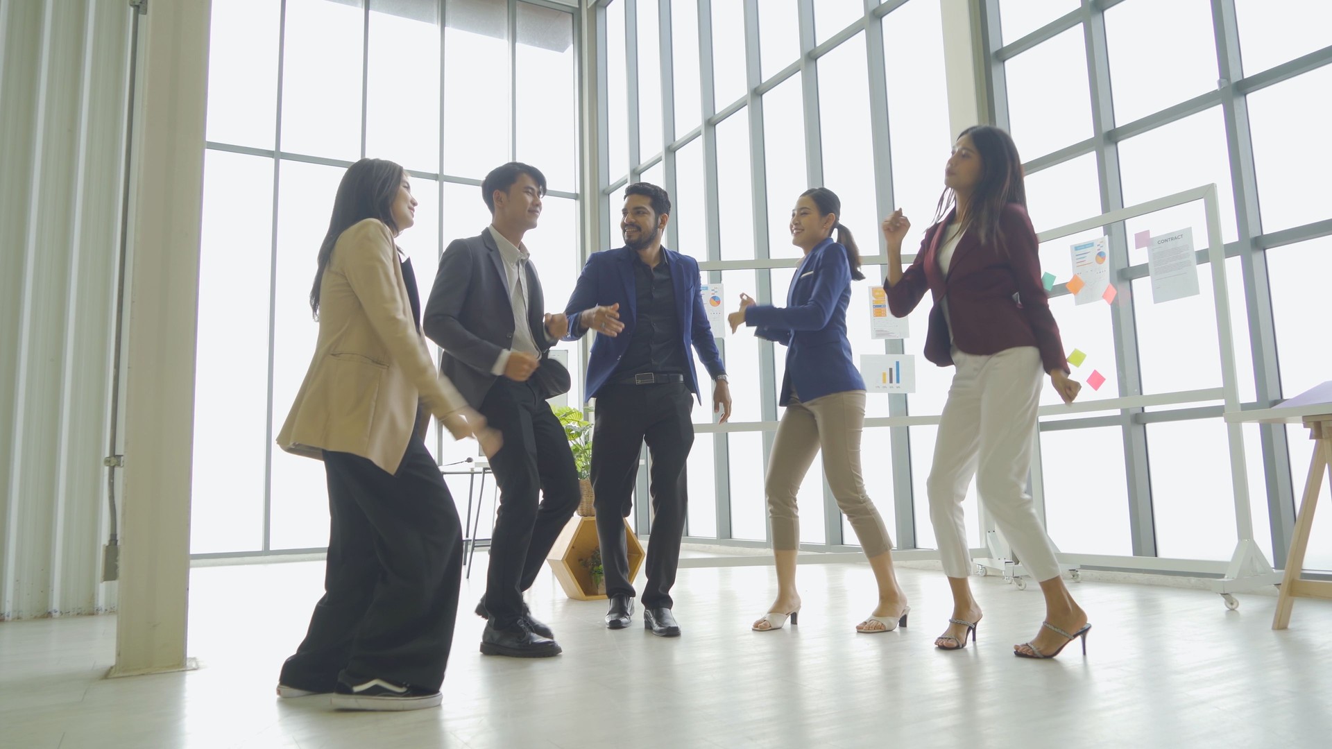 A relax happy group of Asian business team employee people having fun, doing activity, dancing in party in meeting room office. Business analysis. People lifestyle. Celebration. Cooperation
