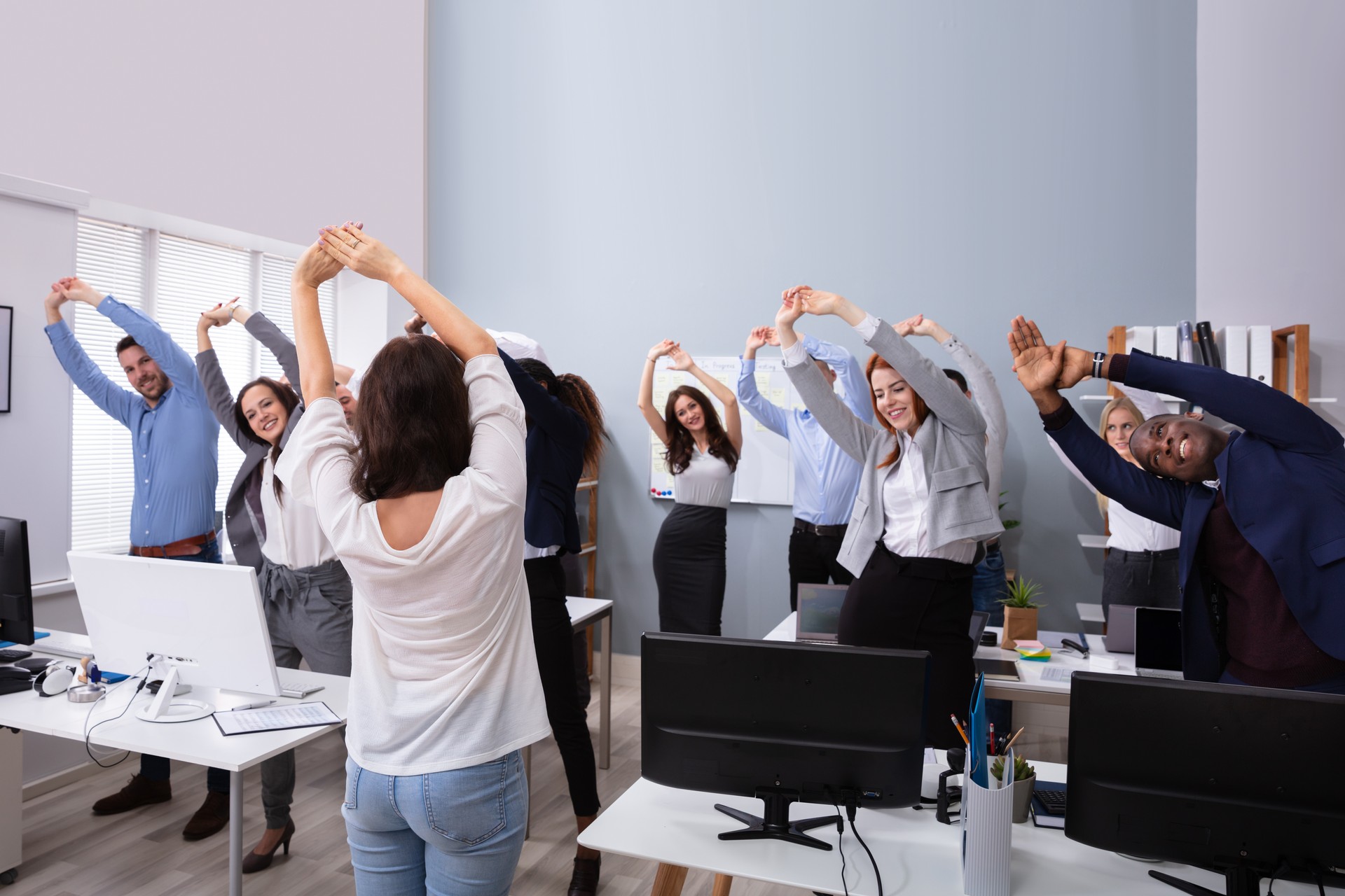 Group Of Smiling Multi-ethnic Businesspeople Doing Exercise